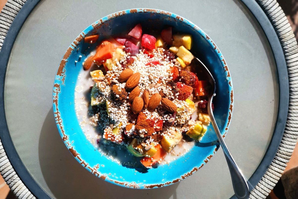 A bowl of healthy oats with nuts on a table - a good way on how to eat healthy and cheap while traveling