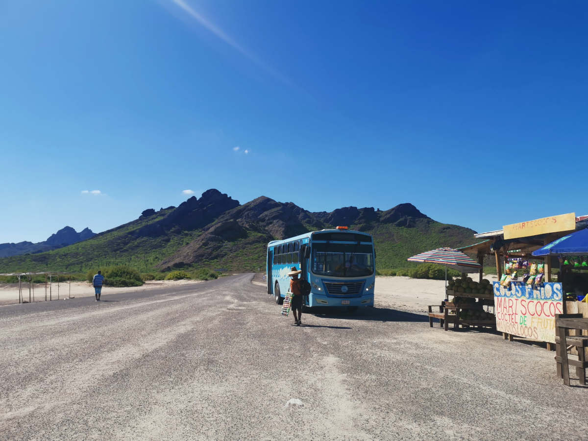Bus in front of mountains at Playa Tecolote near La Paz.