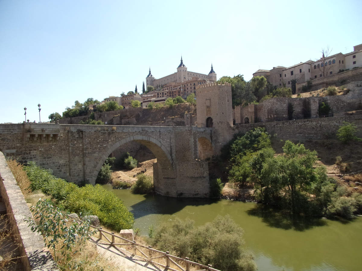 Crossing Puente de Alcántara - one of the best things to do Toledo, Spain
