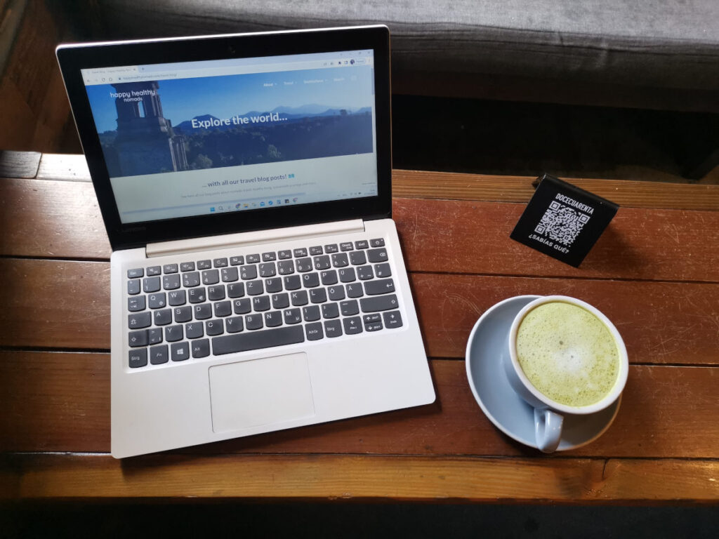 Matcha latte next to a laptop at Doce Cuarenta 