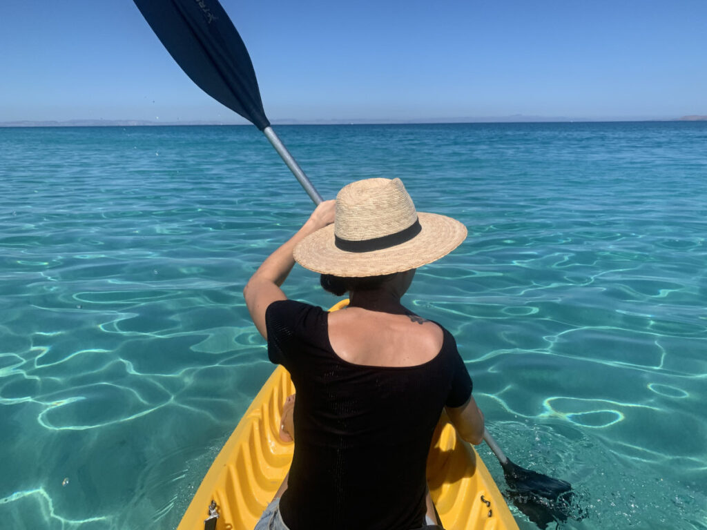 Kayaking through the crystal clear blue water of Playa Tecolote