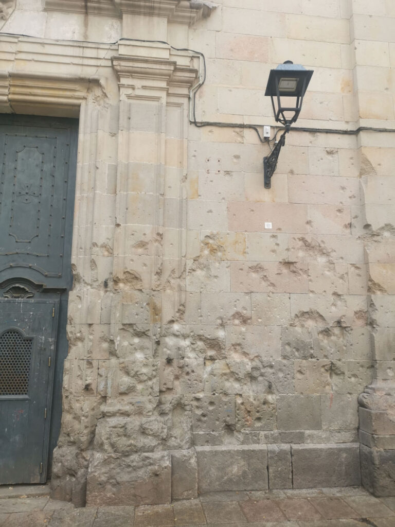 Damage to the walls from bombs at Plaza de San Felipe Neri
