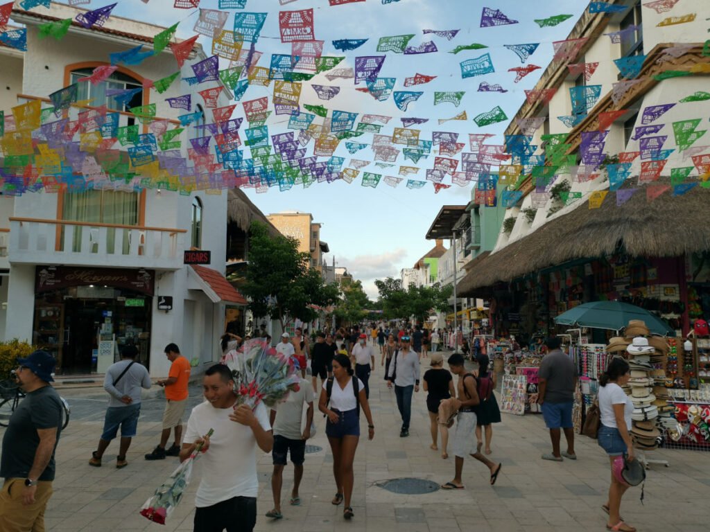 People walking down 5th Avenue the main shopping street in Playa Del Carmen