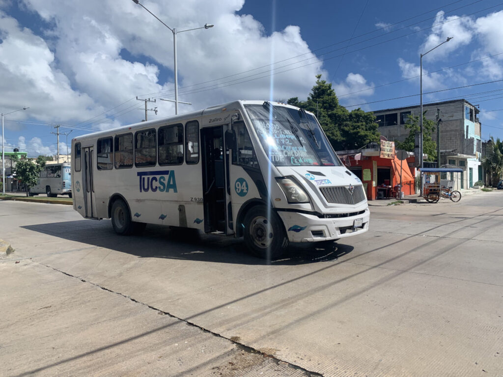 A bus driving down the road to Playa Del Carmen