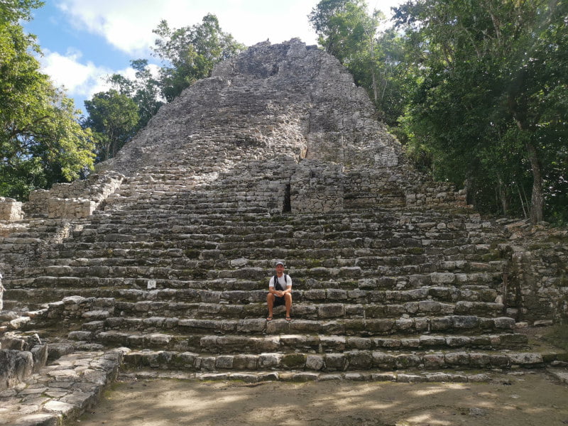 Sitting in front of the pyramid of the church group in Coba