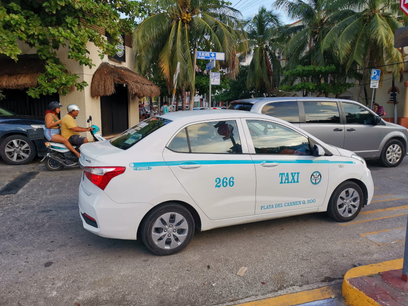 A taxi driving down the road in Playa del Carmen