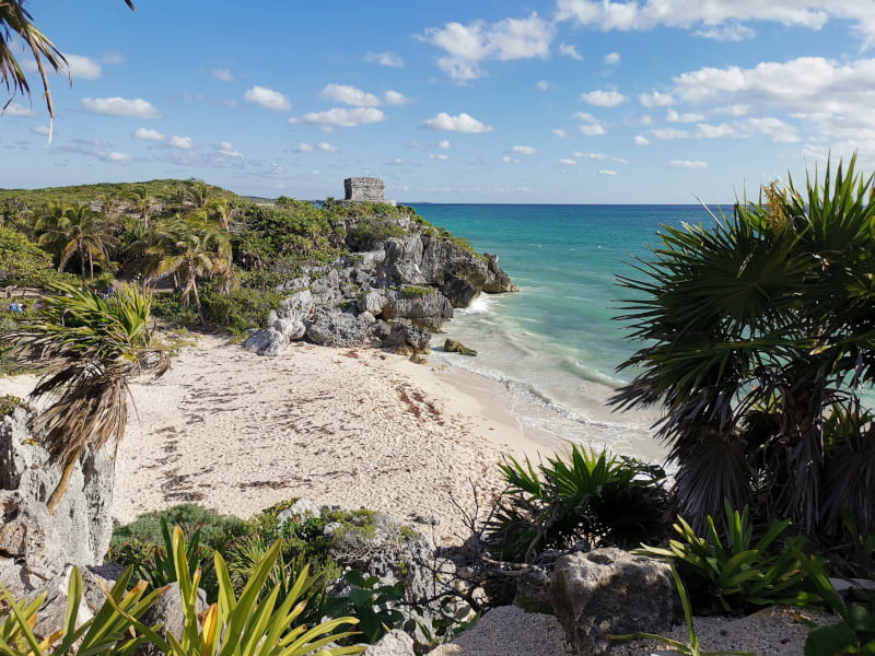 View of the Tulum ruins overlooking a blue bay
