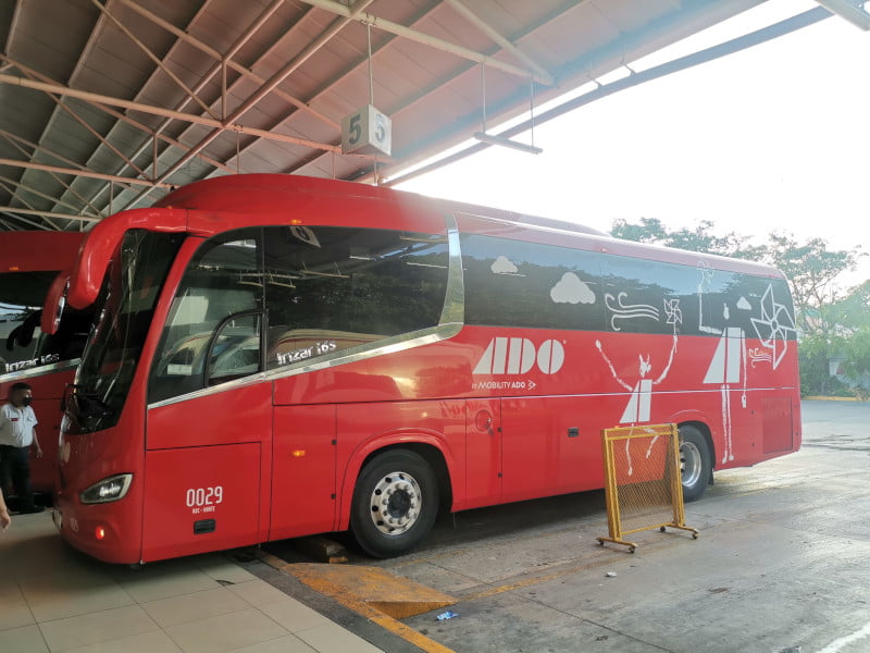 Red ADO bus standing at the Playa del Carmen bus station
