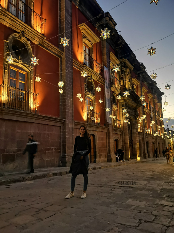 Katharina standing in a street in San Miguel at night with silver stars lit up - a real Christmas flair