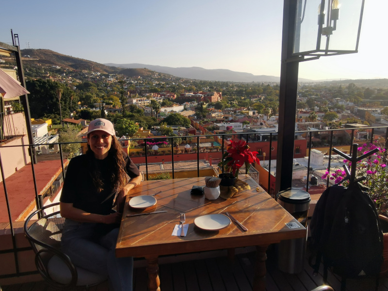 Katharina sitting at a table on the Selina hotel rooftop in San Miguel de Allende