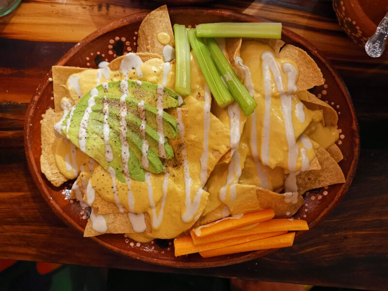 Plate of vegan nachos with avocado and carrots at Soltribe Cantine Vegan restaurant San Miguel de Allende