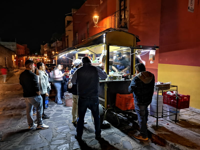 People standing around a taco cart in San Miguel De Allende