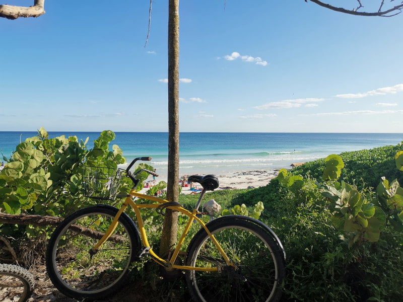 Tulum public beach with yellow bike in front