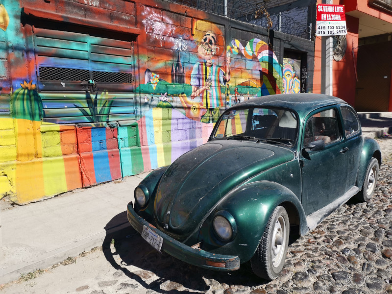 Street art in San Antonio with a VW parked on the street