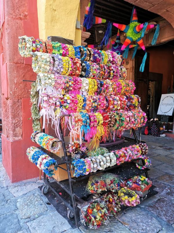 Colorful flower wreaths presented by a street vendor for selling