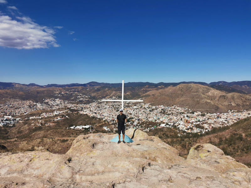 Allan standing in front of the white cross on top of La Bufa overlooking Guanajuato