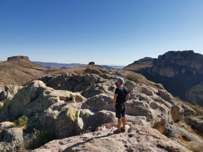 Allan and a dog standing on the top of a rocky pleateu on La Bufa mountain