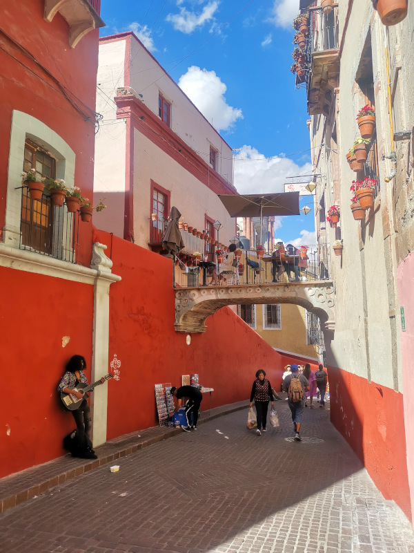 A bridge with tables over a colorful alleyway - one of the top things to do in Guanajuato