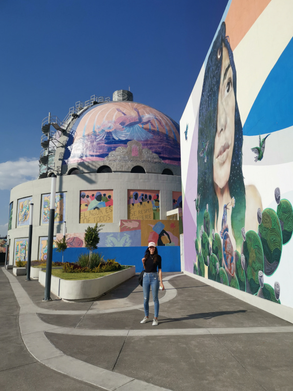 Katharina standing in front of the painted dome of the urban art museum