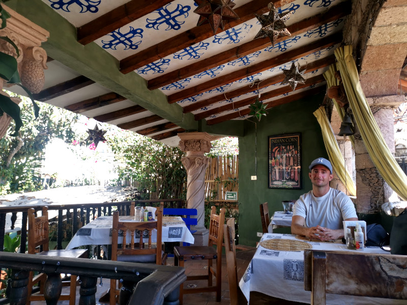 Allan sitting at a table in the Casa Spratling restaurant in Taxco Mexico