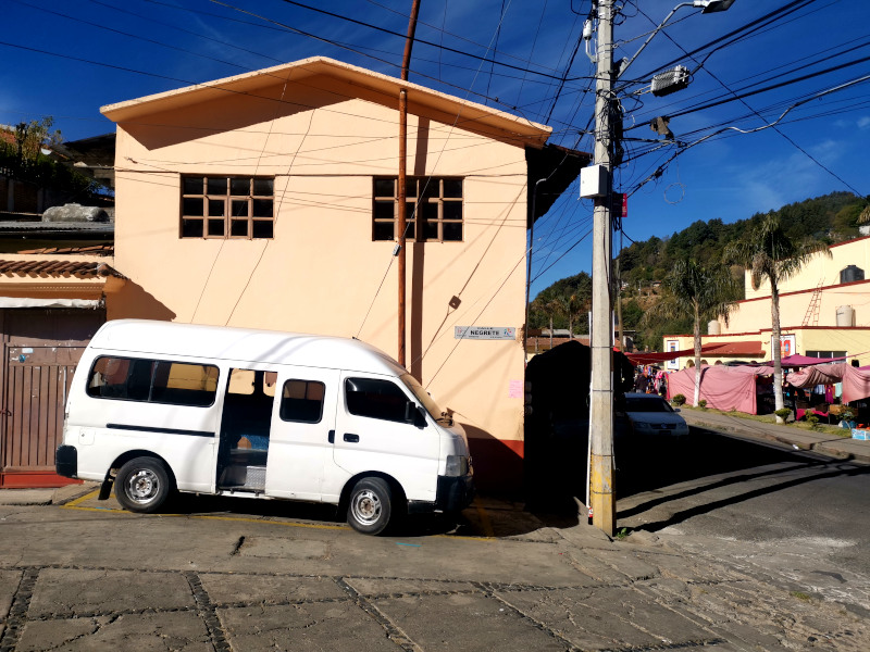 White van with open doors parked in an alleway in Angangueo