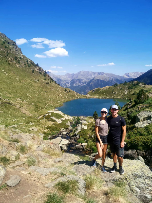 Katharina and Allan standing with their arms around each other with a lake behind them on the Estanys de Tristaina hike