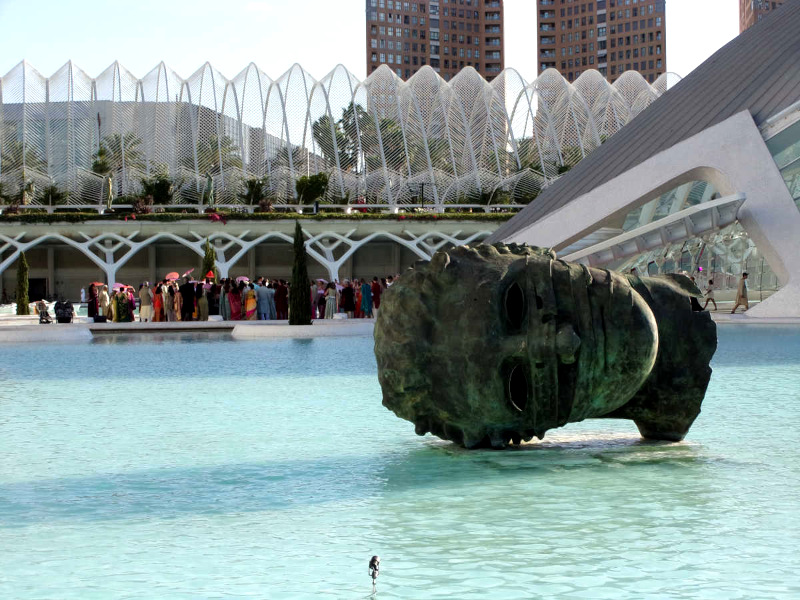 A statue of a head on its side in a pool at the city of arts and sciences an awesome free thing to do in Valencia
