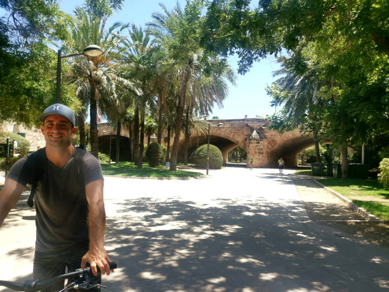 Allan riding a bike through Jardin Del Turia a cool free thing to do in Valencia
