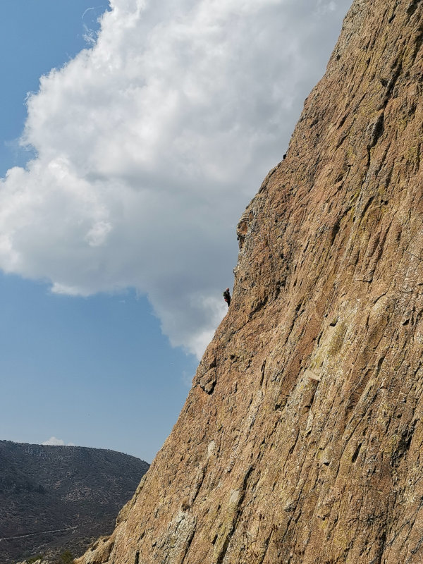 Rock climbers climbing up on a steep side of Bernal