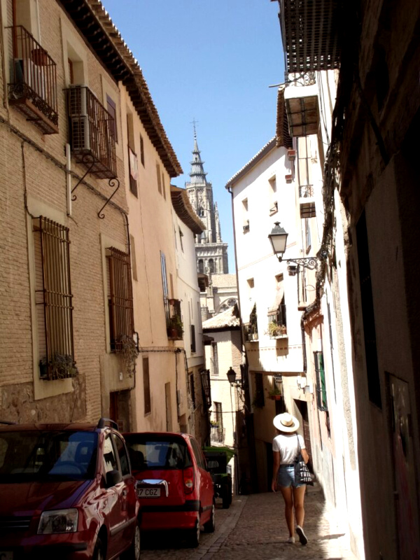 Katharina walking down a narrow street in Toledo Spain