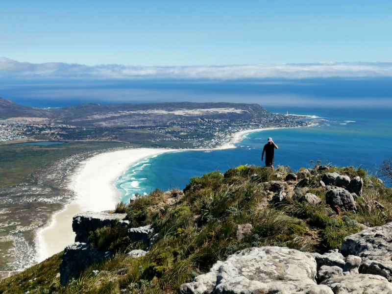 A man walking on the summit of Chapmans Peak one of the best hikes around Cape Town