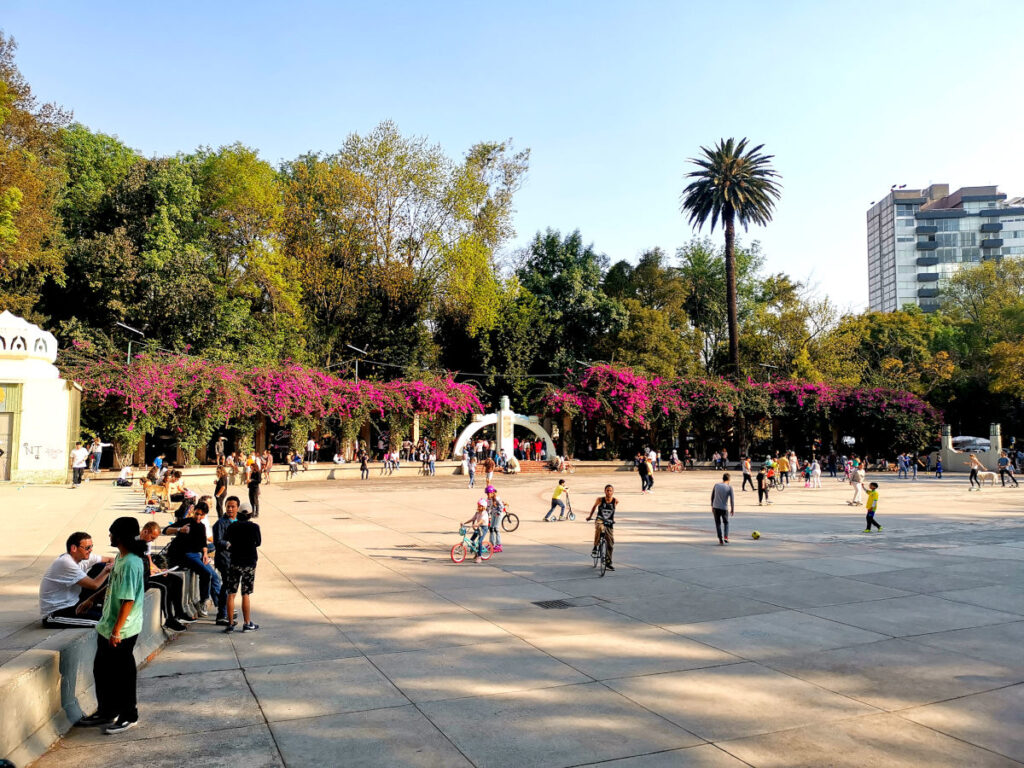 A square in Parque Mexico with people playing in Condesa Mexico City
