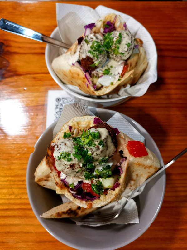 Two falafel pitas from Falafel Nessya served in a bowl - one of our favorite vegan restaurants in Playa del Carmen 