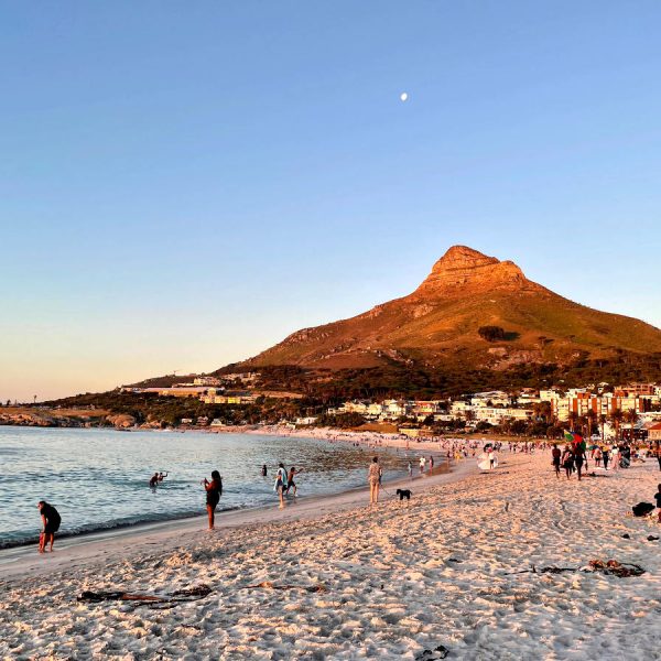 People enjoying Camps Bay one of many fun activities in Cape Town