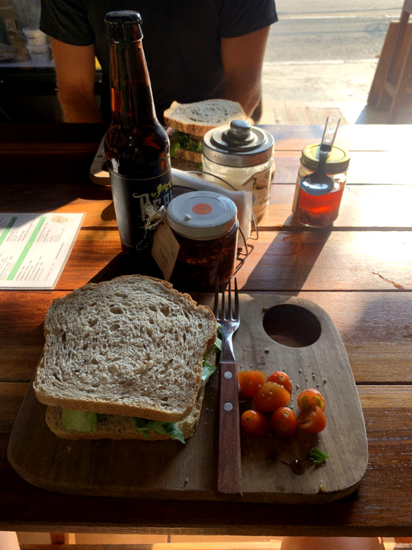 A lentil sandwich from La Chachalca a vegan restaurant in Playa del Carmen served on a wodden cutting board
