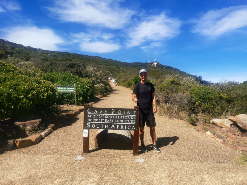 Allan standing next to the sign showing how to get to Cape Point