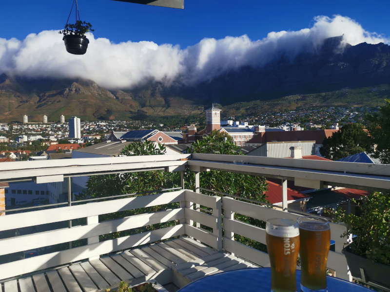 Two beers on a table with Table Mountain in the background