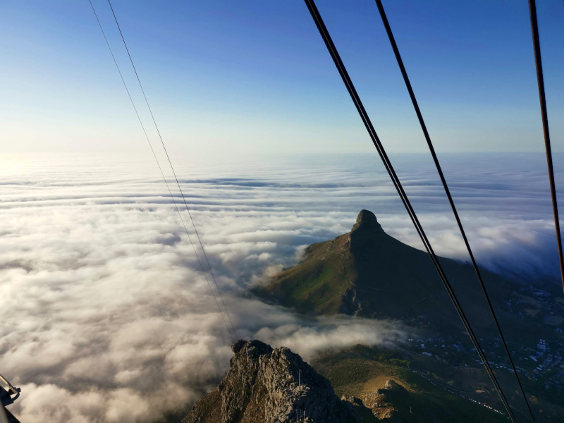 View of Lion's Head while taking the cable car down Table Mountain one of many fun activities in Cape Town