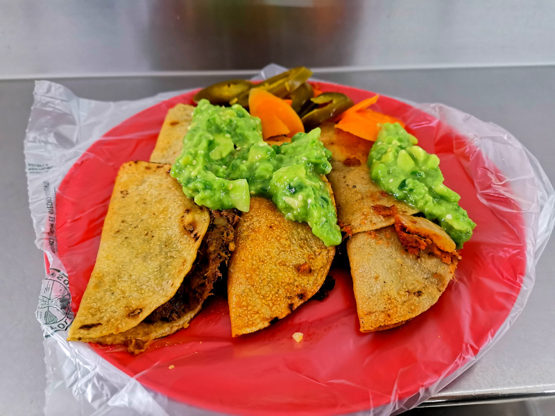 Mexico City street food tacos with avocado on top