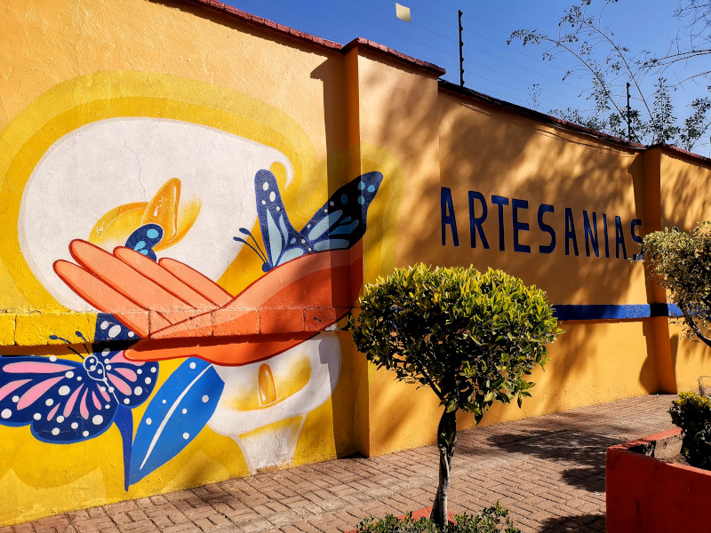 Colorful street art on the outside wall of Mercado de Artesanias la Cuidadela