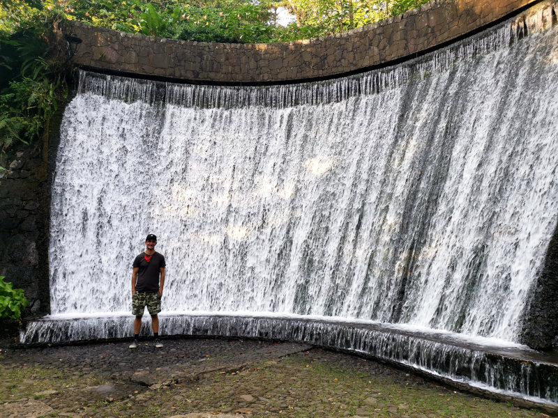 Allan standing in front of a man made waterfall in a national park in Uruapan
