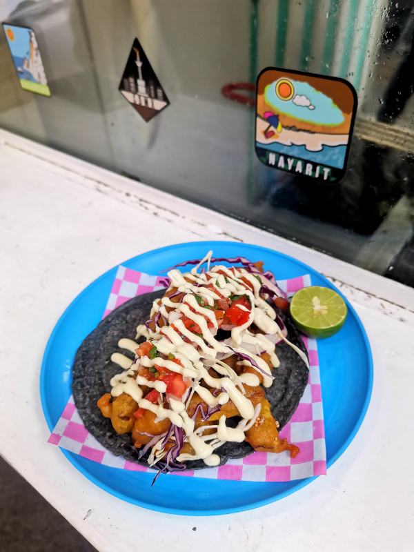 A vegan fried-fish taco on a plate