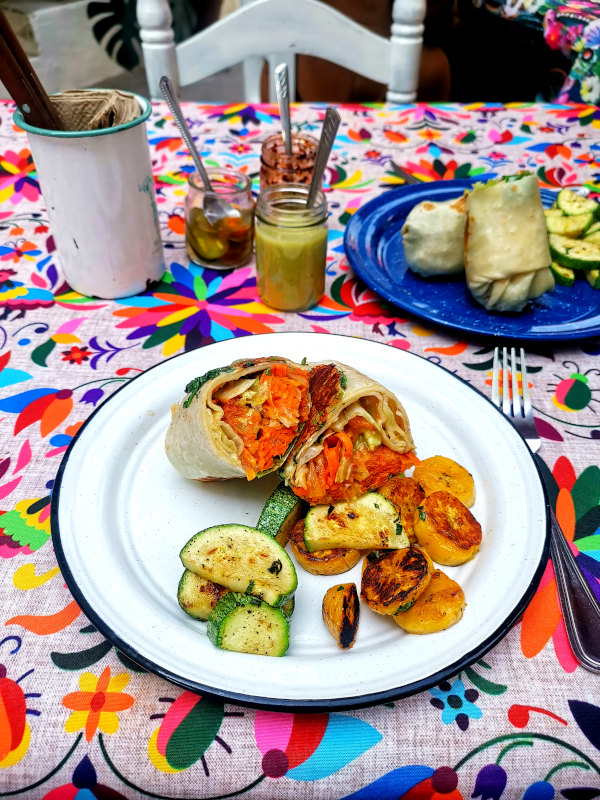 Vegan burrito filled with carrots on a plate