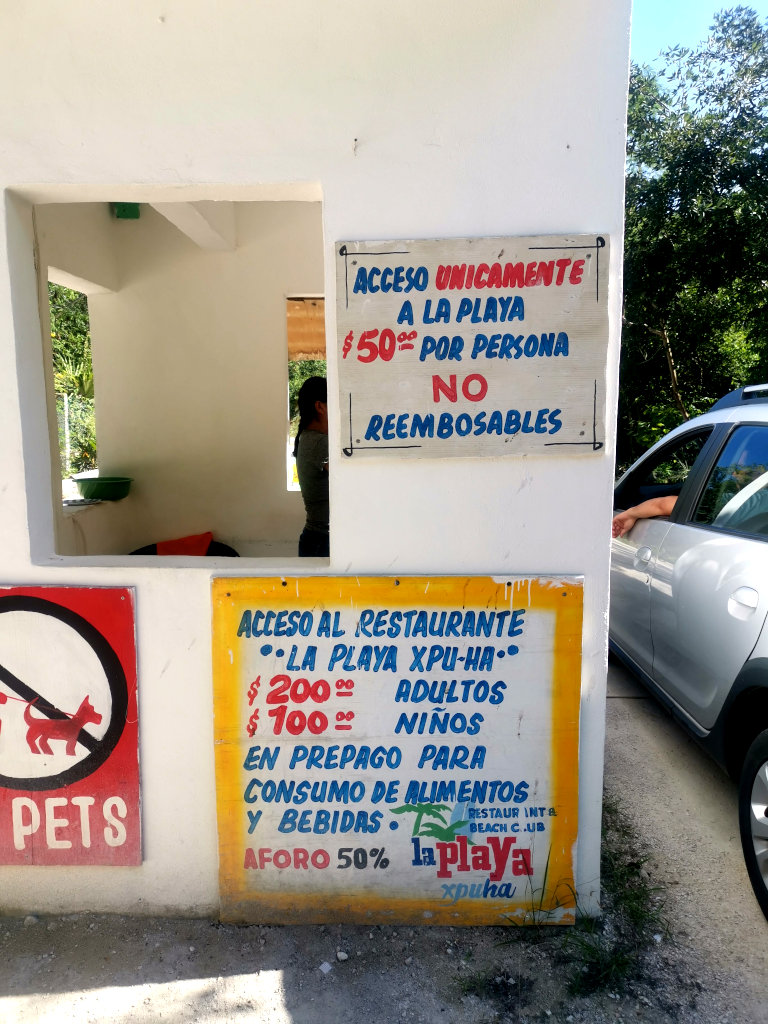 A sign showing the entrance fee for Playa Xpu-Ha