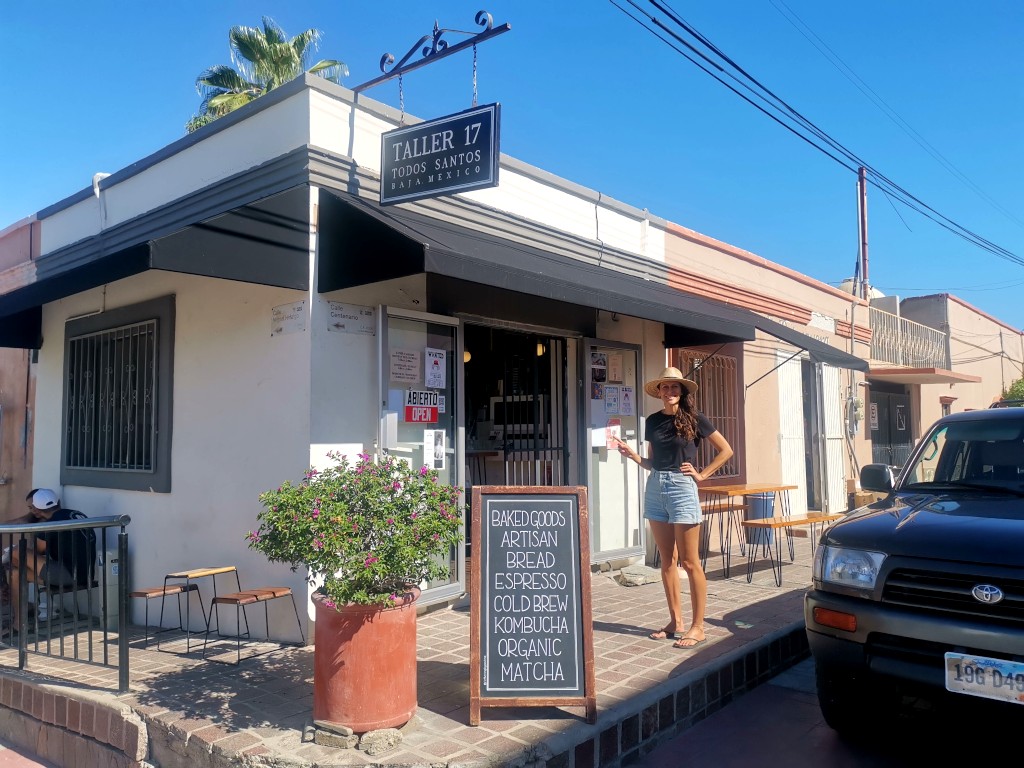 A woman wearing a sombrero outside taller 17 one of the best cafes in todos santos mexico