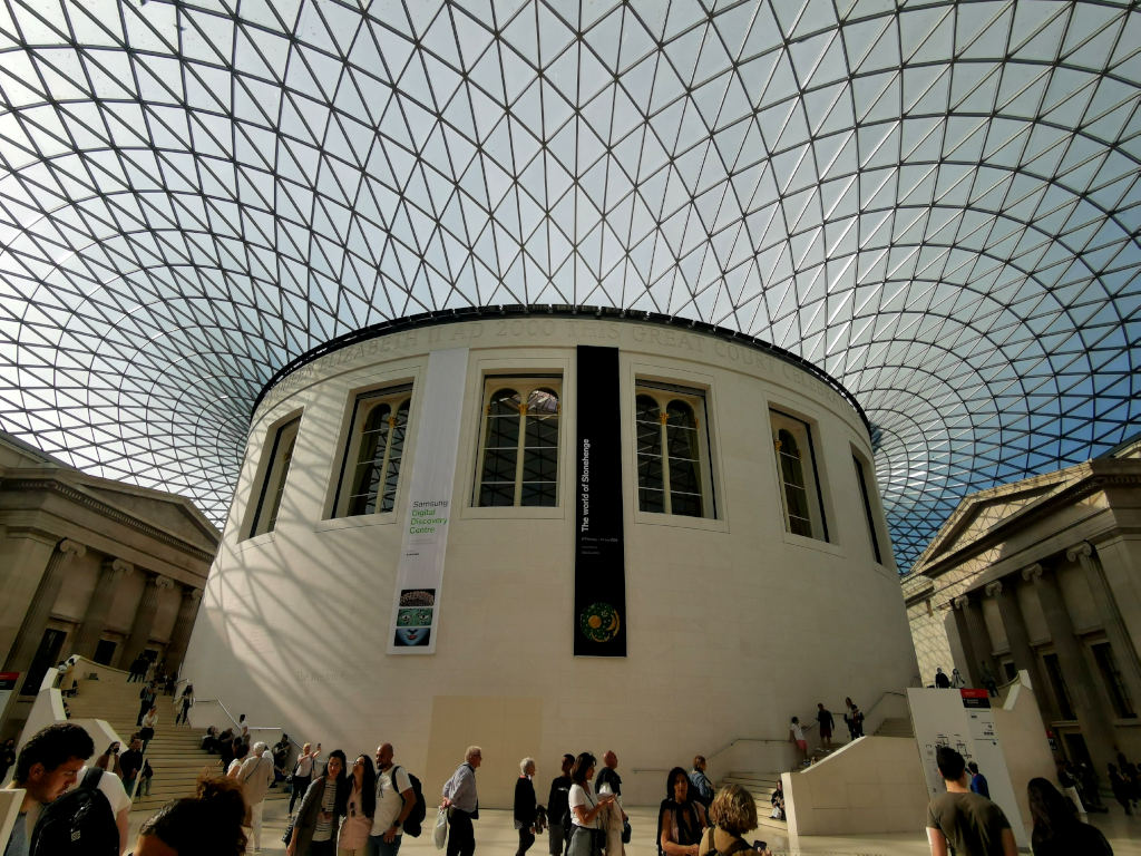 The interior of the British Museum in London with tourists walking around which is totally free to visit