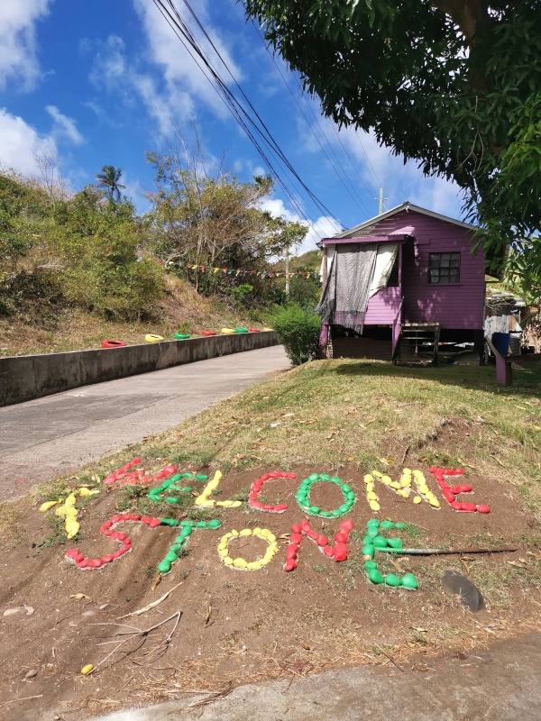The colorful signs made out of stone saying 'Welcome Stone' pointing up the road of the hike