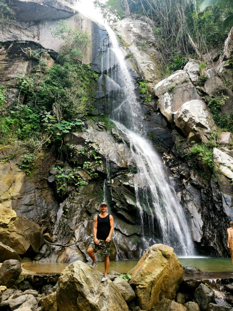 A man standing in front of a waterfall in Yelapa Mexico while voluntering with Workaway