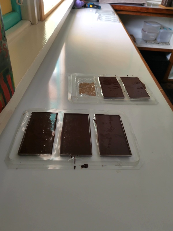 Liquid chocolates in plastic molds on a table