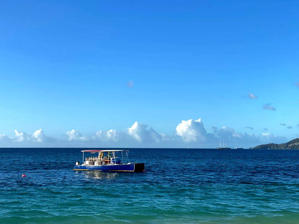 A diving tour boat in grenada off the shore of grand anse beach